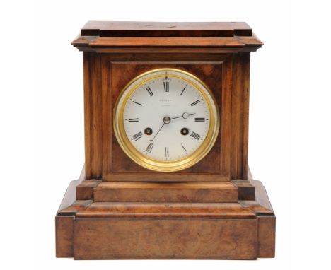 A VICTORIAN WALNUT CASED MANTEL CLOCK, the case of architectural form, the enamelled dial with Roman numerals signed Rowell, 