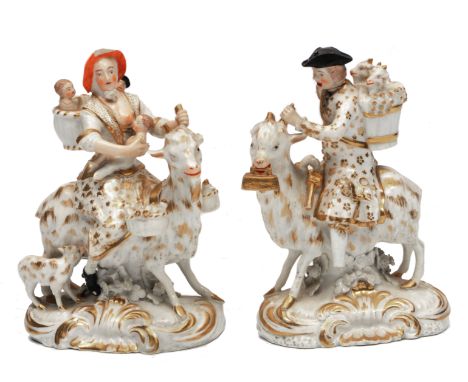 A PAIR OF 18TH CENTURY DERBY PORCELAIN FIGURES of the Tailor and his Wife, each riding a goat, both decorated in gold but eac