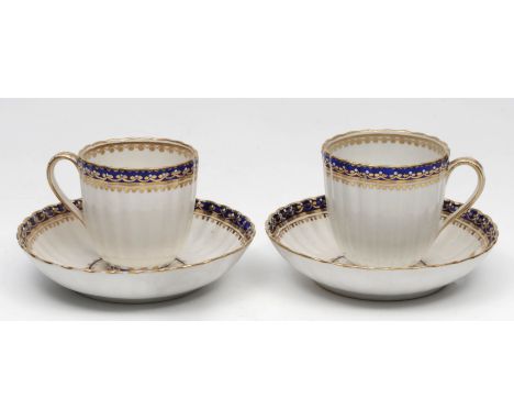 A PAIR OF LATE 18TH CENTURY DERBY PORCELAIN COFFEE CUPS AND SAUCERS with blue and gold bands of decoration, punctuated with w
