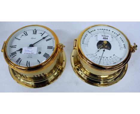 HERMLE TURNED BRASS SHIP'S BELL BULK HEAD CLOCK, the white dial with black Roman numerals striking on a bell together with a 