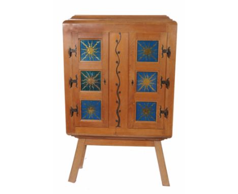 A CONTINENTAL PINE CABINET ON STAND with caddy top, two triple glazed panelled doors, reverse painted with sunburst designs a