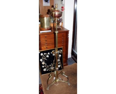 A VICTORIAN BRASS AND COPPER LAMP STANDARD with adjustable stem and on scrolling tripod base terminating in hairy paw feet ( 