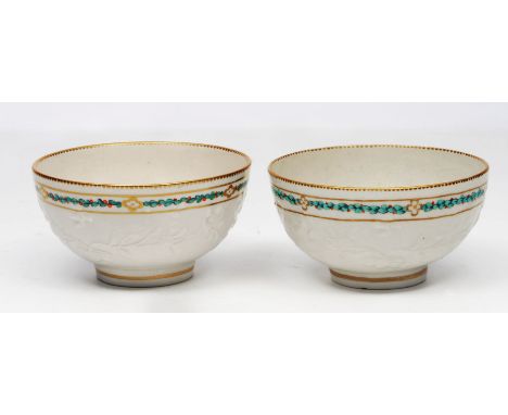 TWO SIMILAR 18TH CENTURY ENGLISH PORCELAIN BOWLS each moulded with flowering prunus blossom and with a band of gilt and ename