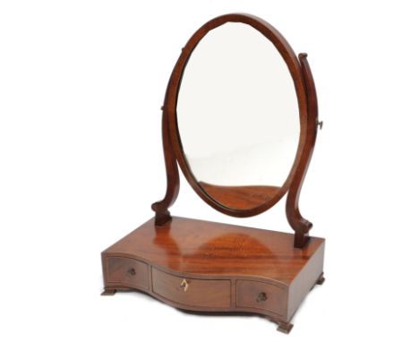 A MAHOGANY DRESSING TABLE MIRROR with oval mirror plate, the base with serpentine front, freize drawers and bracket feet, 44c