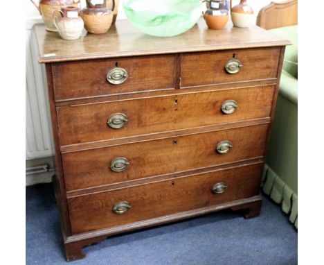 A GEORGE III OAK CHEST of two short and three long drawers with oval brass handles and standing on bracket feet, 106cm wide x