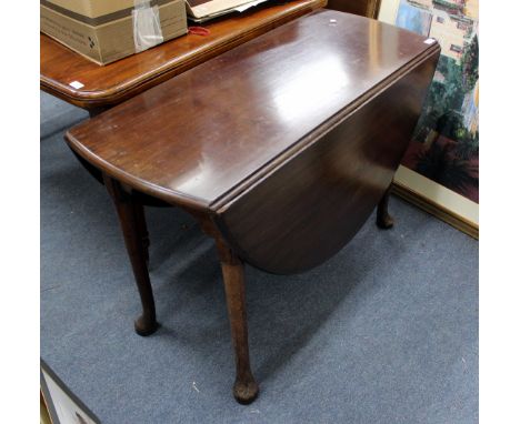 A 19TH CENTURY MAHOGANY DROP LEAF CIRCULAR DINING TABLE with ruled hinged joints and turned tapering legs terminating in pad 