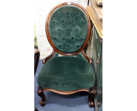 A VICTORIAN SIMULATED ROSEWOOD BUTTON BACK GREEN VELVET UPHOLSTERED NURSING CHAIR with serpentine fronted feet and standing o