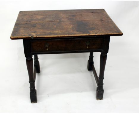 AN 18TH CENTURY OAK SIDE TABLE with plank top,frieze drawer and standing on turned legs, 82cm wide