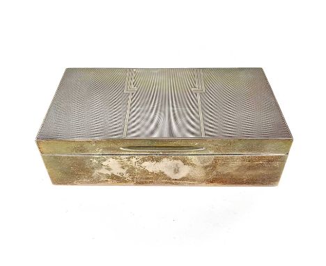 A George VI silver Art Deco cigarette box by Mappin &amp; Webb. The lid with engine turned decoration, hinged to reveal a woo