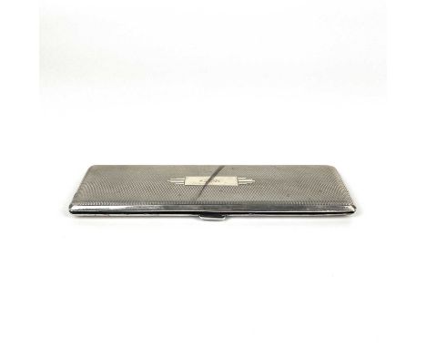 A George V silver Art Deco ladies cigarette case. Of long slender form with engine turned decoration hinged to reveal a doubl