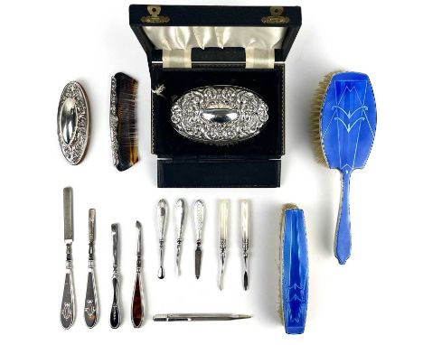 A collection of silver dressing table and manicure implements. Including a George VI blue guiloche enamel hair and clothes br