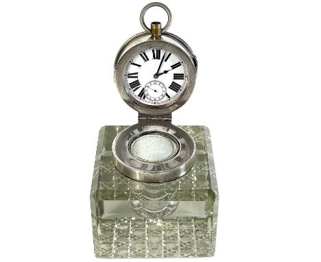 An unusual silver timepiece lidded glass inkwell.  By John Grinsell &amp; Sons, the hinged lid revealing a crown wind timepie