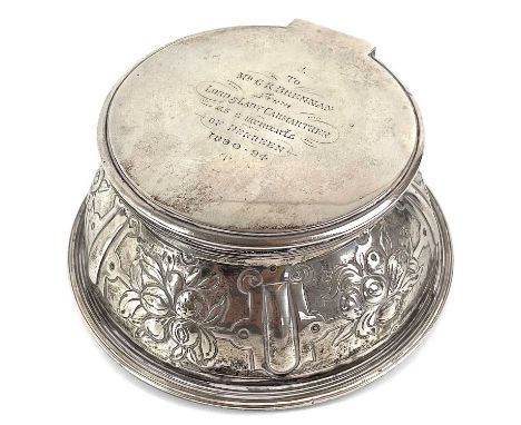 A Victorian silver inkwell by lambert of Coventry Street London. With hinged lid and inner cover, the sides embossed with fru