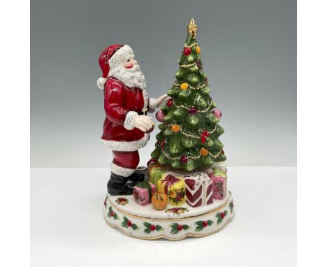 Holiday decoration of Santa in front of tree with presents around the base with base designed in Old Country Roses. Royal Alb