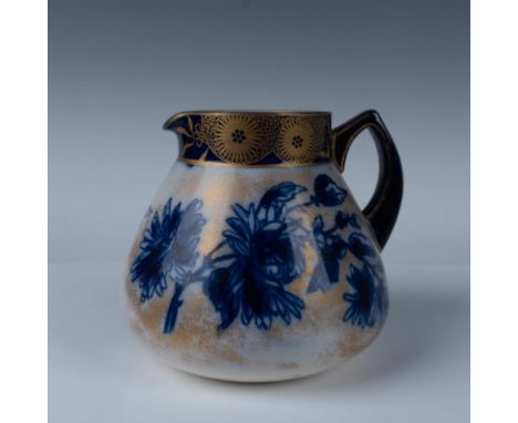 Beautiful handled pitcher with a blue floral design over a gold background. Gilding on the handle and top. Doulton Burslem ba