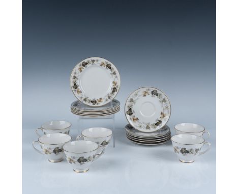 Lovely fall themed cup and saucer set colored in green and amber leaf design with gilt edge. Set includes 6 cups (4"H x 2.75"