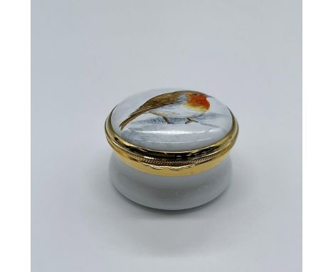 An adorable miniature white enamel box with a hand painted robin and golden accents. This item has its original box measuring