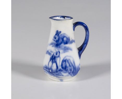 A white pitcher featuring exquisite blue artwork depicting rabbits lounging peacefully in a serene field. Royal Doulton backs