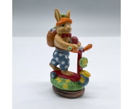 This festive bonbonniere showcases an easter bunny on a scooter, composed of porcelain over enamel. This item has its origina