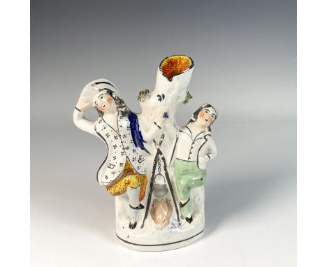 Hand painted and hand decorated porcelain vase featuring a hollow trunk between two joyful figures in amusing pose. Issued: 2
