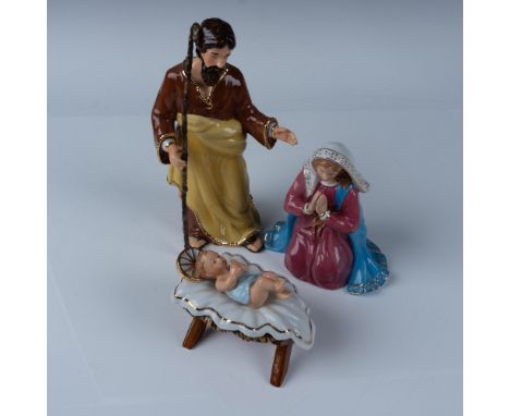 Three exquisite figurines from the Holiday Traditions series featuring Joseph in a warm brown and yellow ensemble, Mary in a 
