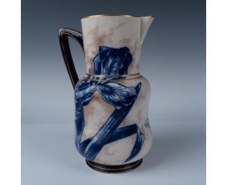 Irregular shaped pitcher with handle. Decorated with cobalt blue flowers on an ivory and gold background. Gilt detailing on t