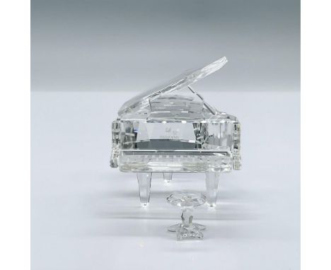Made out of clear crystal, this figure comes with a small crystal stool and mirror base. This item has its original box measu