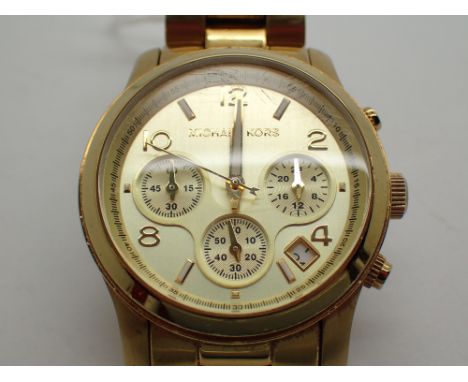 Gents original yellow metal Michael Kors wristwatch CONDITION REPORT: This item is working at lotting.