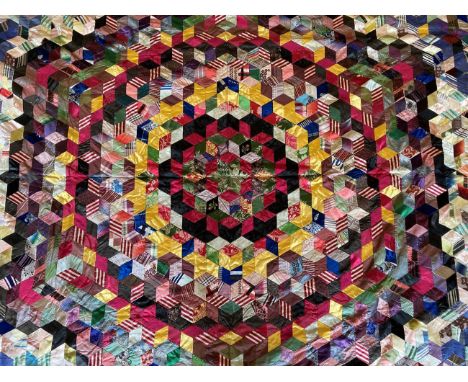 Victorian Crazy Patchwork Bed Cover, in the tumbling block pattern around a central star, incorporating mainly silks and sati