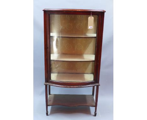 An Edwardian mahogany bow fronted display cabinet raised on square tapered legs and spade feet, H 122 x W 62 x D 40cm 