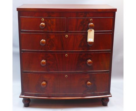 A Victorian flame mahogany bow fronted chest of two short over three long drawers raised on bun feet, H 106 x W 96 x D 50cm 