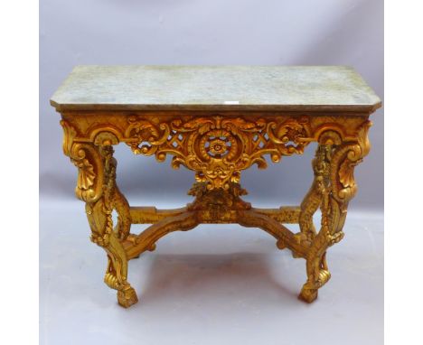 An Italian style giltwood console table having a green marble top, the base decorated with shells, acanthus leaves and scroll