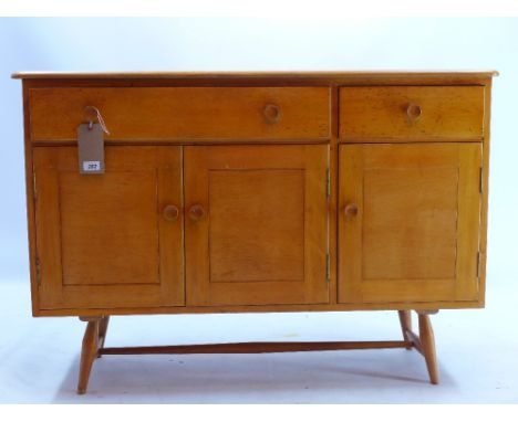 A Ercol style sideboard with two drawers above three cupboard doors raised on spindle legs, H 83 x W 120 x D 46cm 