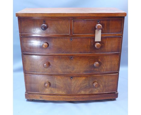 A Victorian mahogany bow fronted chest of two short over three long drawers and raised on bun feet H 101 x W 107 x D 50cm 