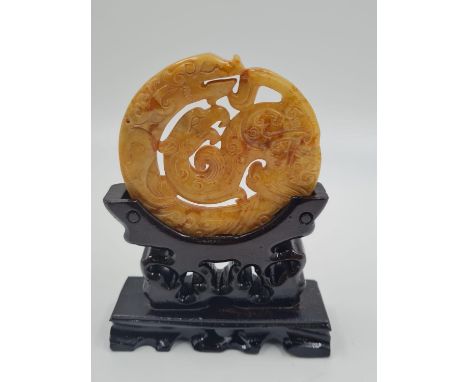 A Chinese, carved, yellow-orange, jade disc (amulet?) with two protecting mythical beasts. Presented on its own, custom made,