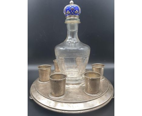 AN ANTIQUE RUSSIAN SILVER AND ENAMEL VODKA SET COMPRISING  OF A SILVER TRAY, 6 SILVER SHOT CUPS AND A CUT GLASS DECANTER WITH