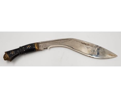 A vintage kukri knife with gilded lions head, on handle and decorative engraving on blade. Comes with scabbard. Tip to handle