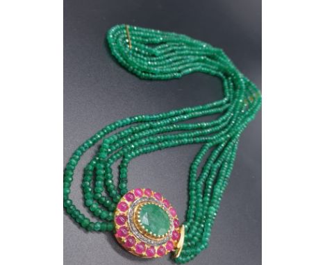 A Five Row Green Onyx necklace with a Ruby clasp cum brooch with a halo of diamonds and rubies , 22 inches long 