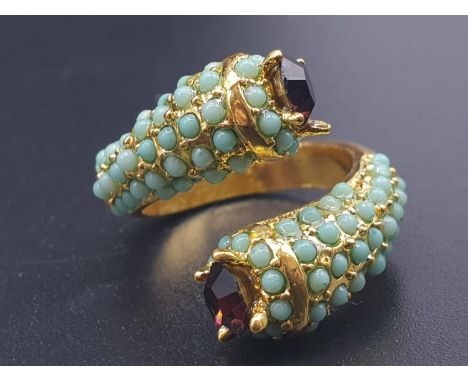 An unusual yellow metal (untested) ring with turquoise and amethysts in its presentation box. Ring size: N (adjustable), weig