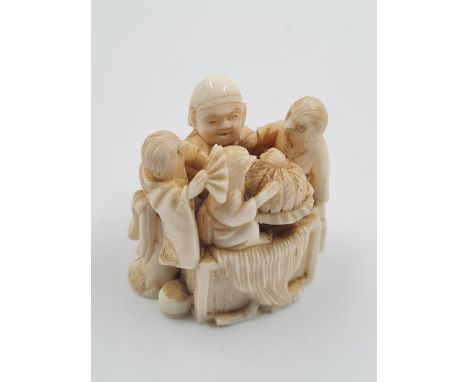 AN ANTIQUE JAPANESE NETSUKE FROM THE MEIJI PERIOD. A RARE PIECE SHOWING INTRICATE DETAIL.WEIGHING 45gms AND STANDING ONLY 4cm