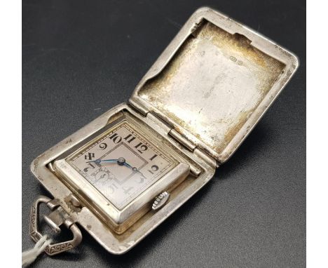 A vintage, possibly antique swiss-made travelling clock in a silver case. AS found. 3 1/2 x 3 1/2 cm. 39g total weight. 