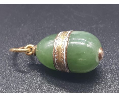 A RUSSIAN 14CT GOLD AND JADE EGG PENDANT WITH A DIAMOND SET IN THE BOTTOM.3.5gms and 1.5cms 