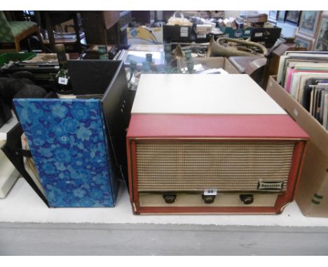 A vintage Dansette conquest record player and an assortment of 45 rpm records 1950s-1980s