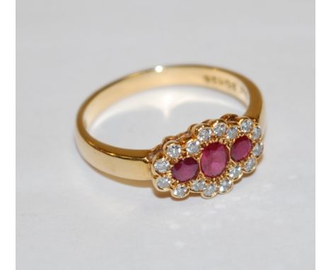 A modern ladies 18ct gold, ruby and diamond dress ring, size N 