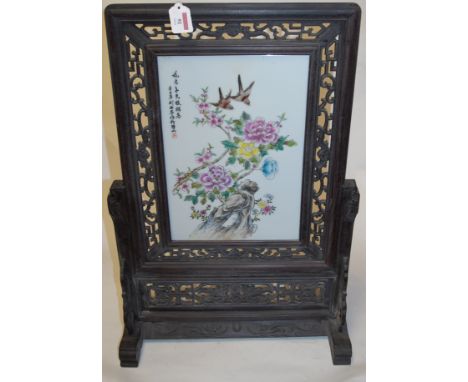 A 20th century Chinese table screen, the central porcelain panel decorated with birds amongst flowers, within fret carved har