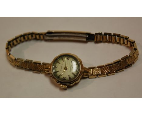 A ladies Baume 9ct gold cased cocktail watch having manual wind movement and on gilt metal expanding bracelet