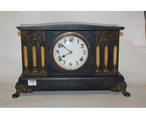 An early 20th century ebonised cased mantel clock, of architectural form, having a paper dial and eight day movement striking