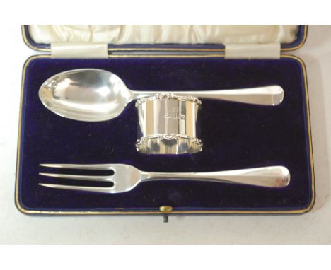 An early 20th century cased silver fork and spoon with associated silver napkin ring