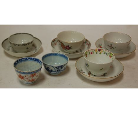 A near pair of early 19th century porcelain tea bowls and saucers, probably Newhall, together with two other tea bowls and sa