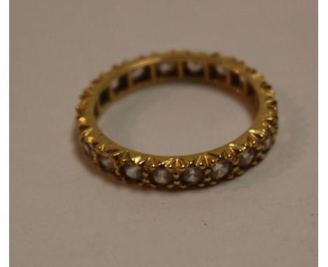 An 18ct gold and white sapphire set eternity ring (one stone missing)